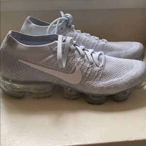 Woman’s grey and white Nike’s Air VaporMax